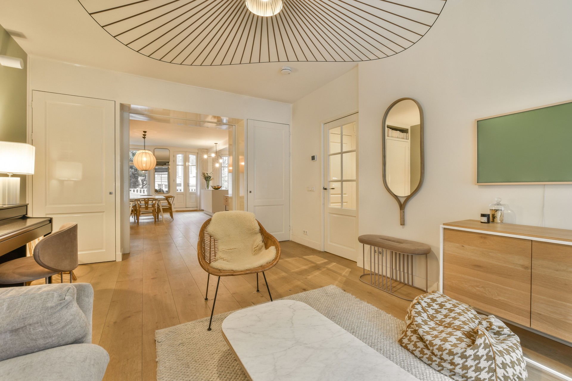 a living room with a white couch and a chair